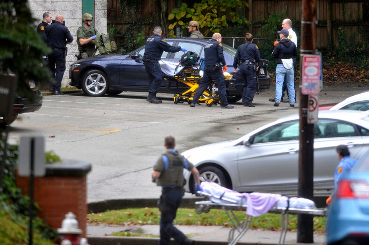 Police and medical personnel gather on the side of Tree of Life Synagogue on Saturday, Oct. 27, 2018, in Pittsburgh