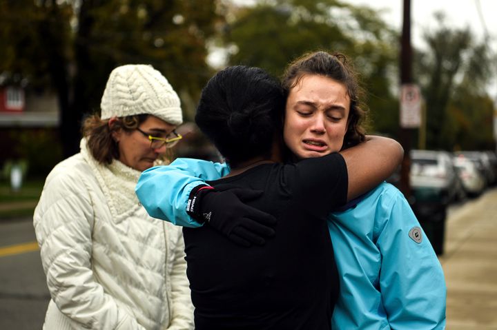 From left, Kate Rothstein looks on as Tammy Hepps hugs Simone Rothstein, 16, on the intersection of Shady Avenue and Northumberland Street after multiple people were shot at the Tree of Life Congregation synagogue.