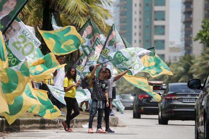 Supporters of Jair Bolsonaro, far-right lawmaker and presidential candidate of the Social Liberal Party (PSL), attend an electoral campaign rally in front of Bolsonaro's condominium at Barra da Tijuca neighborhood in Rio de Janeiro, Brazil on October 27, 2018. 