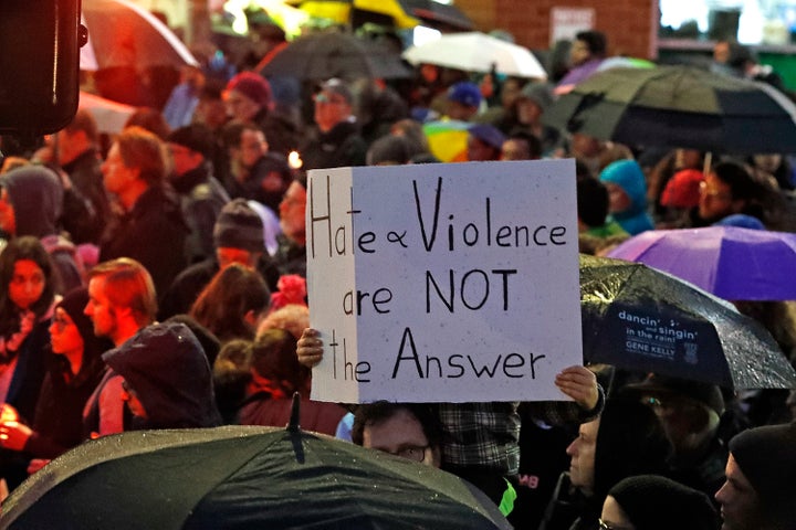 A young boy holds a sign in the Squirrel Hill section of Pittsburgh during a memorial vigil for the victims of the shooting at the Tree of Life Synagogue where a shooter killed 11 people and wounded six, including four police officers, on Saturday.