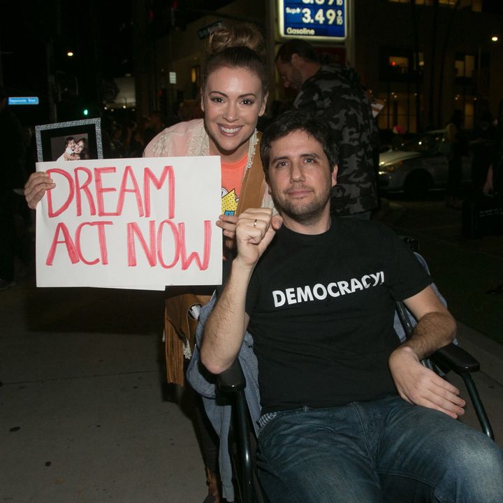 Ady Barkan, seated in a wheelchair, attends a rally for the Dream Act in Los Angeles in January 2018. Alyssa Milano, an actress and activist, accompanies him.