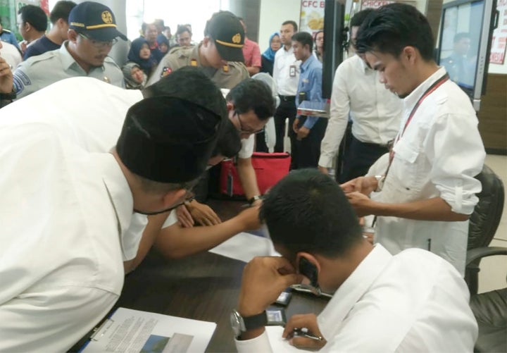 Lion Air officials check the passenger list of flight JT610.