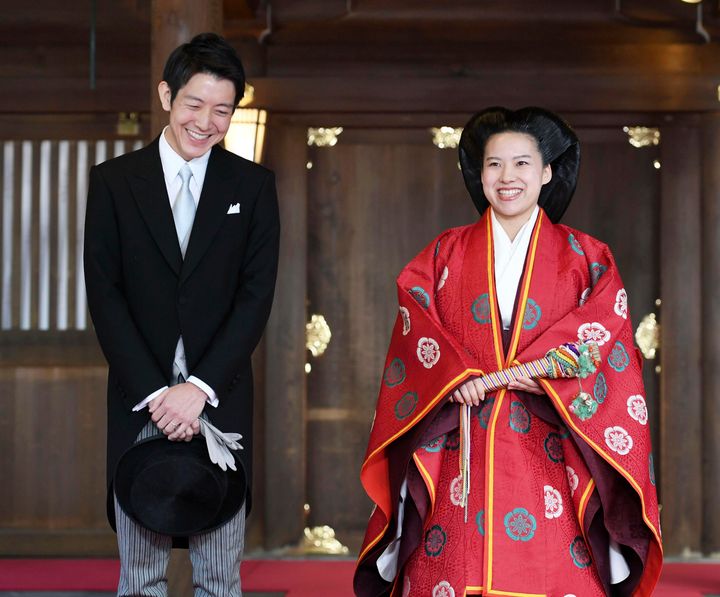 Japanese Princess Ayako, right, dressed in traditional ceremonial robe, and groom Kei Moriya, left, after their wedding ceremony at Meiji Shrine in Tokyo on Monday.