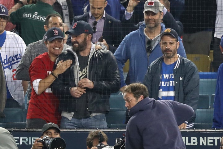 Matt Damon and Ben Affleck celebrate the Red Sox' victory while Jimmy Kimmel looks on in disappointment.
