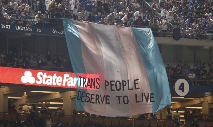 A banner with the words ‘Trans People Deserve to Live’ is displayed during Game Five of the 2018 World Series between the Los Angeles Dodgers and the Boston Red Sox at Dodger Stadium on October 28, 2018 in Los Angeles, California. 