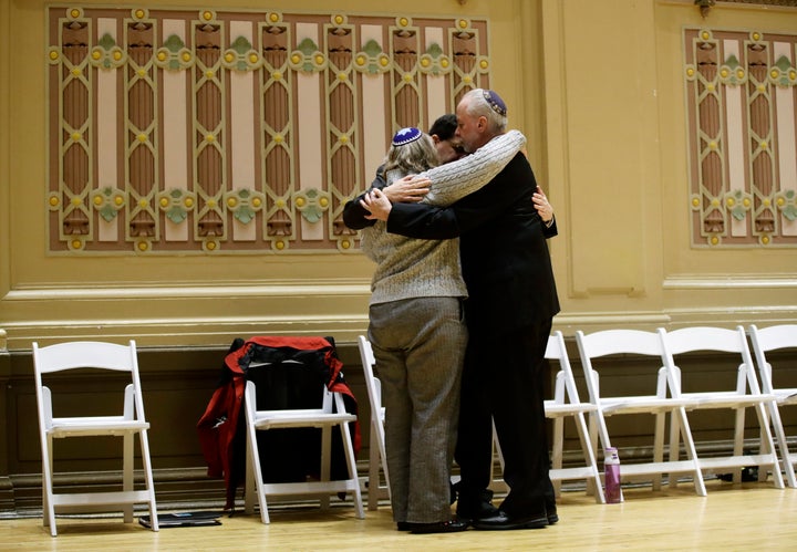 Rabbi Jeffrey Myers, right, of Tree of Life/Or L'Simcha Congregation hugs Rabbi Cheryl Klein, left, of Dor Hadash Congregation and Rabbi Jonathan Perlman during a community gathering held in the aftermath of a deadly shooting at the Tree of Life Synagogue in Pittsburgh, Sunday, Oct. 28, 2018. (AP Photo/Matt Rourke)