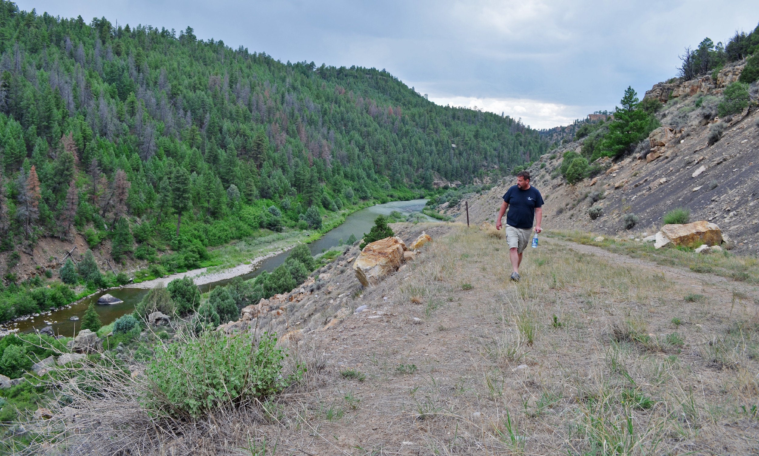 Conway walks above the Rio Chama, in Heron Lake State Park.