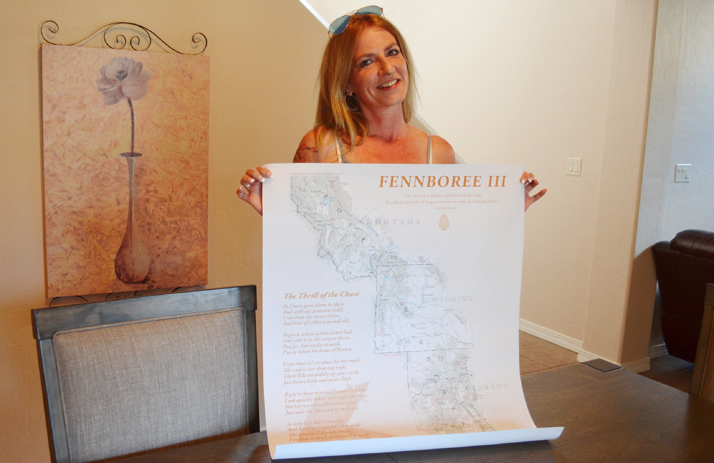 Sacha Johnston of Albuquerque holds up a poster from Fennboree, an annual gathering of Forrest Fenn treasure hunter