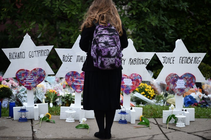 A woman stands at a memorial outside the Tree of Life synagogue after a shooting there left 11 people dead in the Squirrel Hi