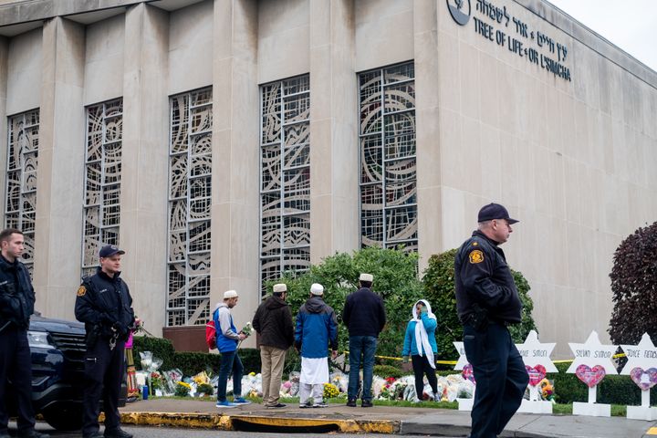 Mourners gather in front of the makeshift memorial at the site of a mass shooting at Pittsburgh's Tree of Life synagogue.