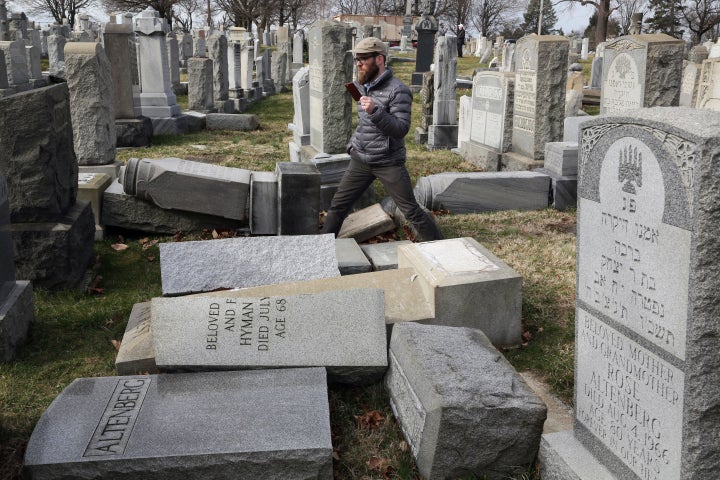 Rabbi Joshua Bolton of the University of Pennsylvania's Hillel center surveys damaged headstones at Mount Carmel Cemetery in Philadelphia on Feb. 27, 2017.