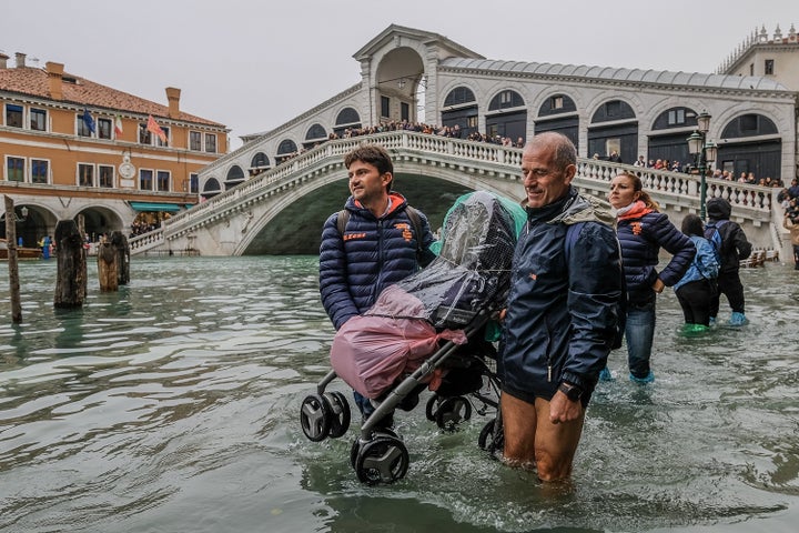 Tourists continued to visit popular destinations in Venice, even as city officials removed normal bridges for high water.