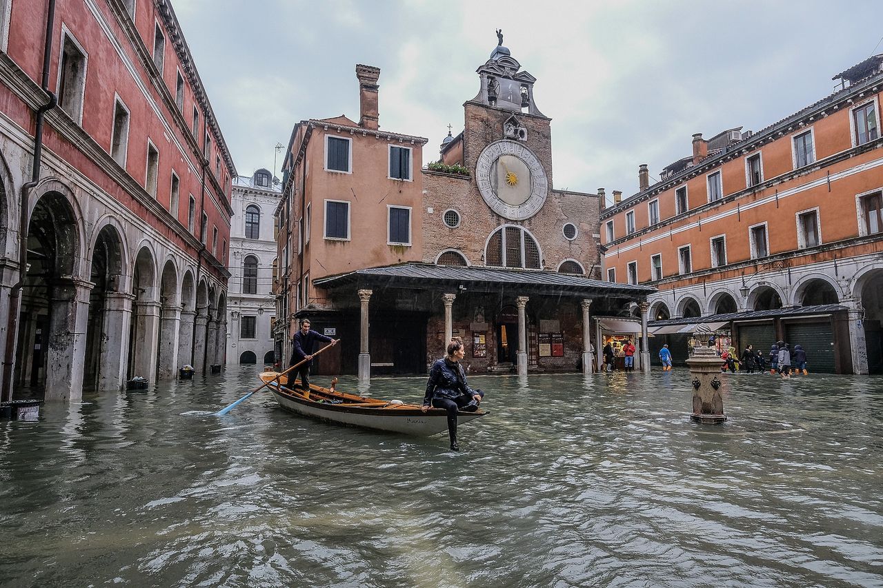 A typical Venetian boat sails in 'Campo San Giacometto'.