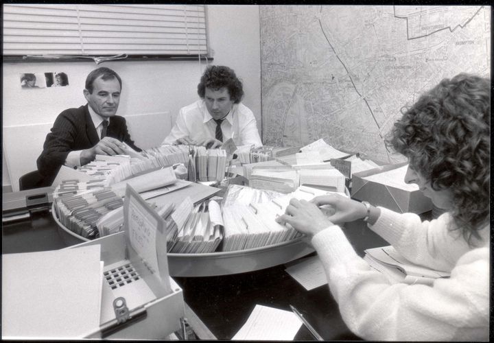 Detective Superintendent Nick Carter (left) checks the rotary card index with members of the Suzy Lamplugh inquiry squad at Kensington Police Station in the aftermath of her disappearance 