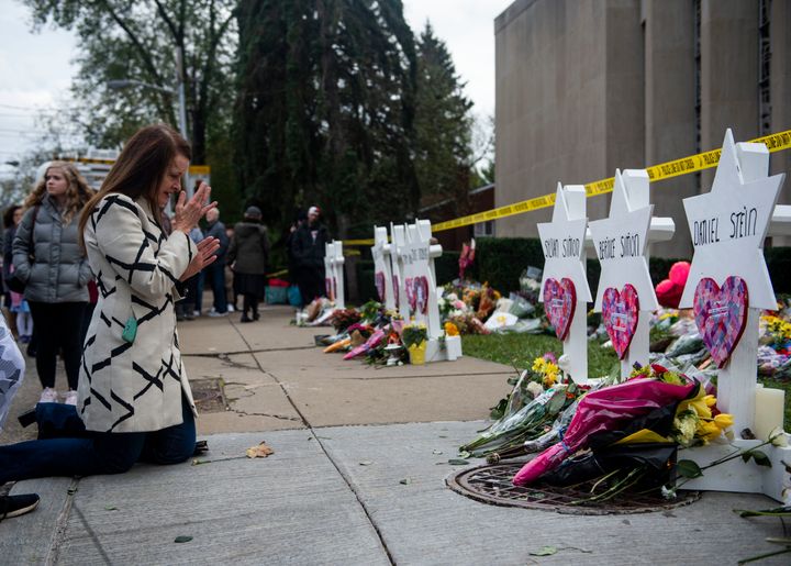 A woman prays outside the Tree of Life synagogue in Pittsburgh, where a white supremacist killed 11 people.