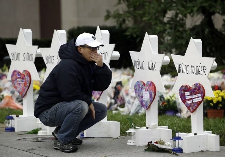 A mourner pauses in front of a memorial for those killed in a deadly shooting at the Tree of Life synagogue in Pittsburgh, Oc