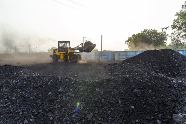 A bulldozer loads coal onto a train in Chandwa, Jharkhand, India, on Thursday, May 17, 2018.