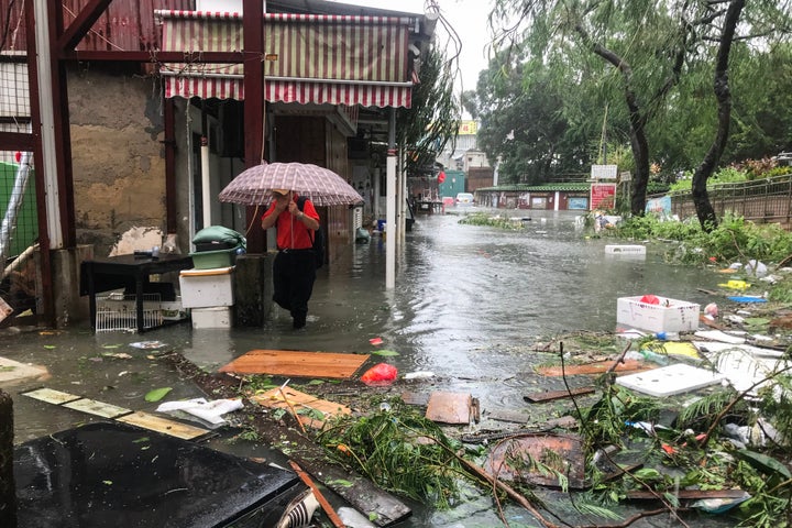 A man wades through floodwaters in the village of Lei Yu Mun during Super Typhoon Mangkhut in Hong Kong on Sept. 16.