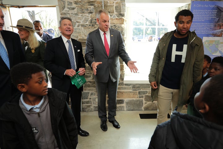 Zinke and Chip Akridge (standing to the left), founder of the Trust for the National Mall, tour the newly restored Old Canal Lockkeeper's House on the mall in October.