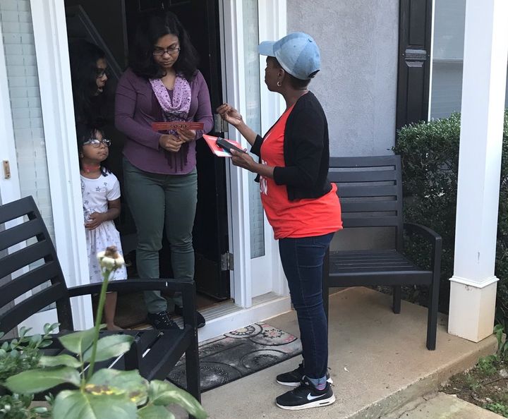 Nilaja Fabien, a 46-year-old nanny originally from Trinidad, talks to a woman in Gwinnett County, Georgia, about Stacey Abrams' campaign for governor.