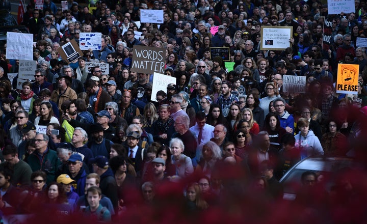 Thousands of people march through Pittsburgh to protest President Donald Trump's visit just days after 11 people were killed in a shooting at Tree of Life synagogue.