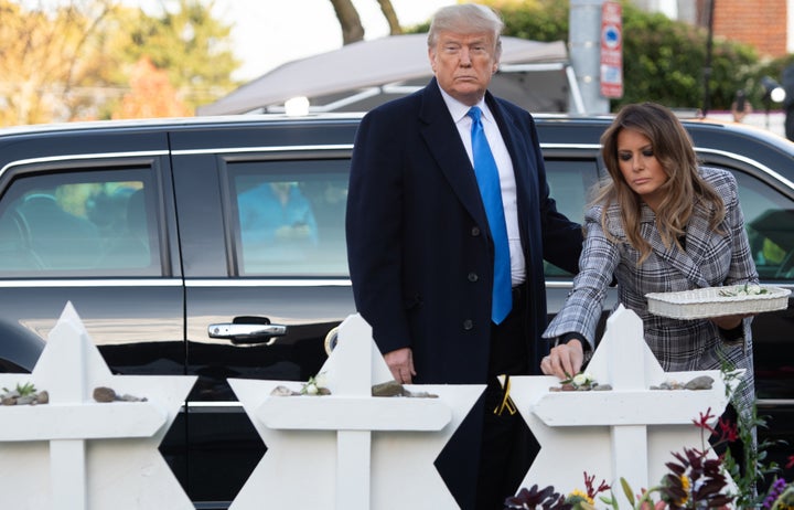 President Trump and first lady Melania Trump lay flowers on 11 makeshift Star of David memorials erected outside the synagogue.