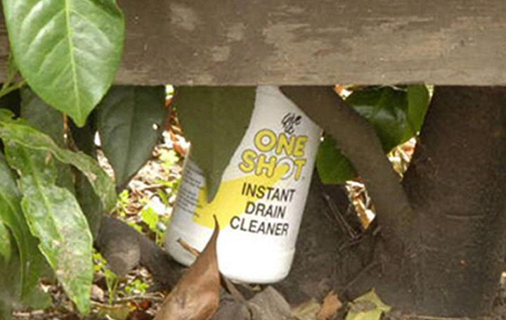 A bottle of strong acid seen discarded in an archive police handout photo.