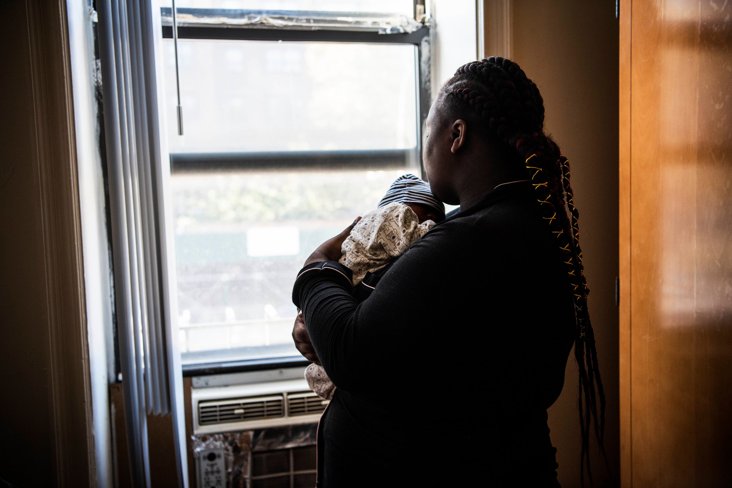 Amy, not her real name, looks out the window of the domestic violence shelter where she currently lives. She's not allowed to