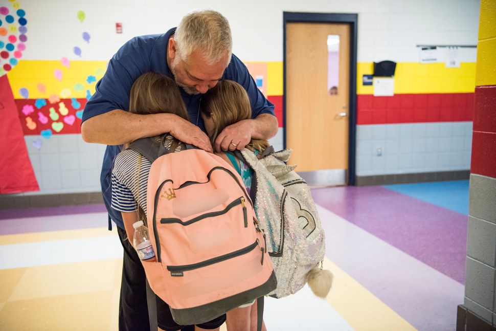 Greg Cruey, a teacher at Southside K-8 school, greeting students in the morning. <i>This photo has been edited to protec