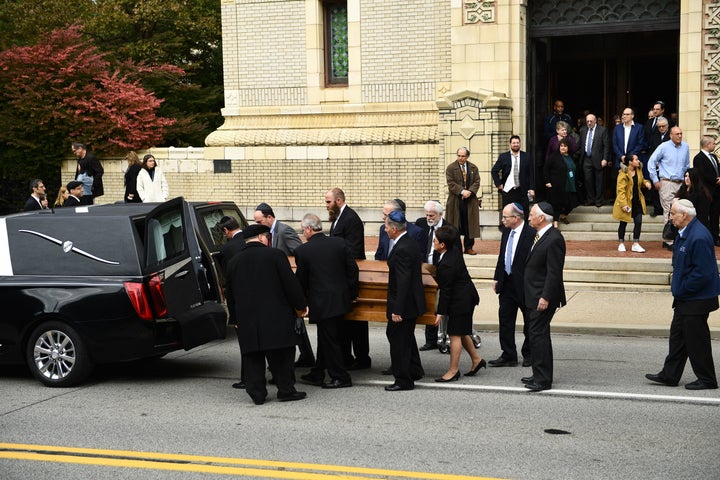 Mourners gather as a casket is carried outside the Rodef Shalom Congregation, where the funeral for shooting victims Cecil Rosenthal and David Rosenthal was held Oct. 30, 2018 in Pittsburgh, Pennsylvania.