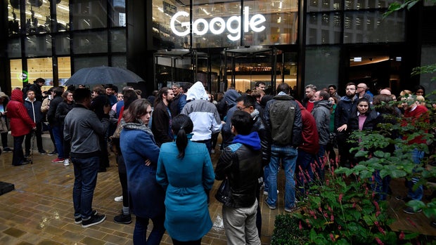 Workers stand outside the Google offices after walking out as part of a global protest over workplace issues, in London, Britain, November 1, 2018. REUTERS/Toby Melville