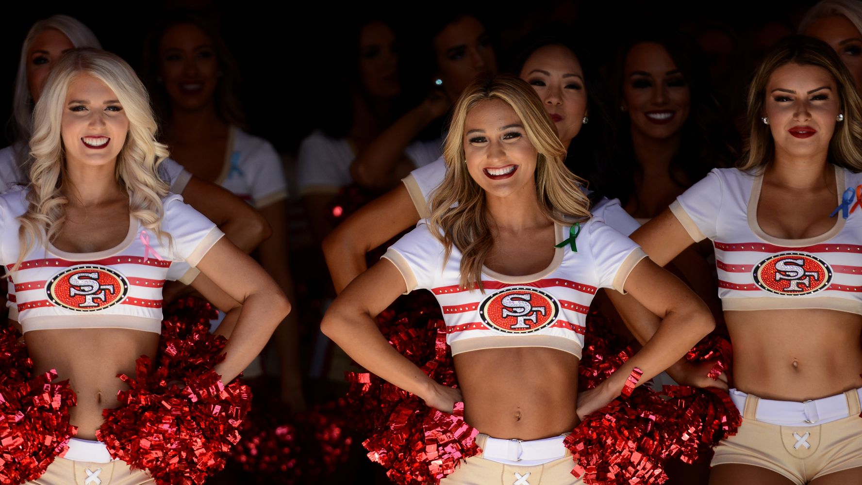 49ers cheerleader takes a knee during anthem before Raiders game