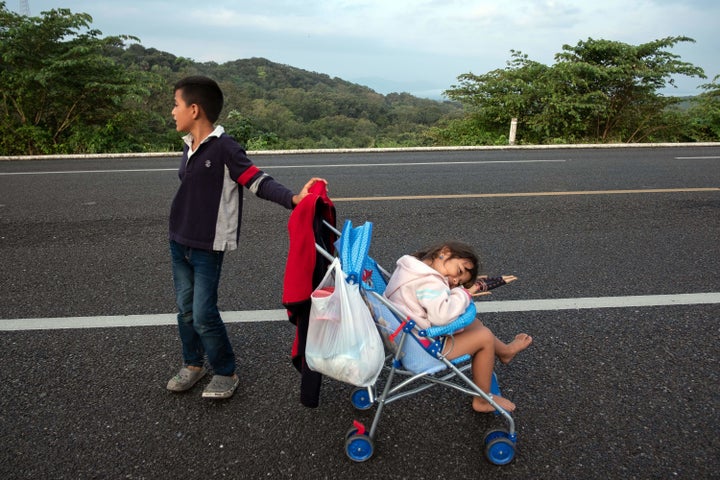 Two children who are part of the migrant caravan of Central American refugees that the president claims are attempting to inv