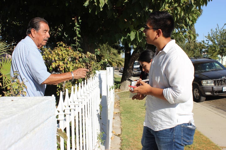 <p>Bryan Osorio, 22, of Delano, talks to an 80-year-old Delano voter. Osorio is a University of California, Berkeley, graduate running for Delano City Council to address drinking water problems and defend immigrant families. </p>