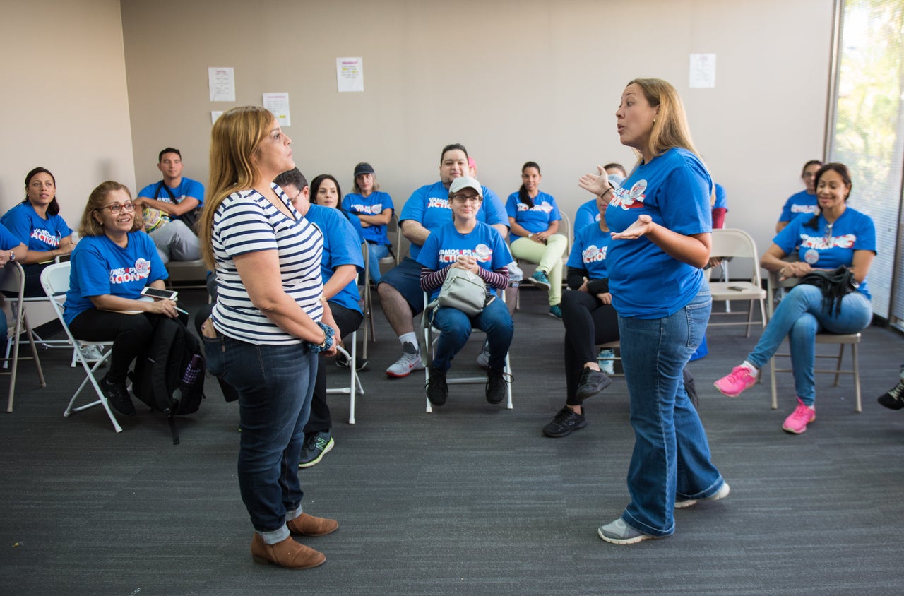 Canvassers working with Vamos4PR participate in a training exercise on how to approach people at their homes.