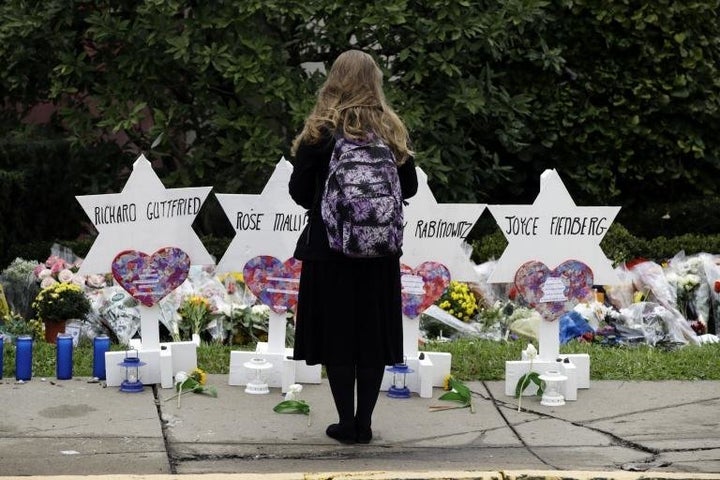 A mourner stands in front of a memorial set up for some victims of the synagogue shooting in Pittsburgh.