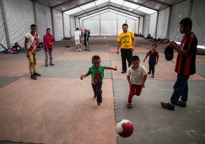 People traveling north from Central America play football at a temporary shelter in Mexico City on Nov. 5. Mexico’s ambassador to the U.S. said his country was working “very closely with the United States government” on regional migration.