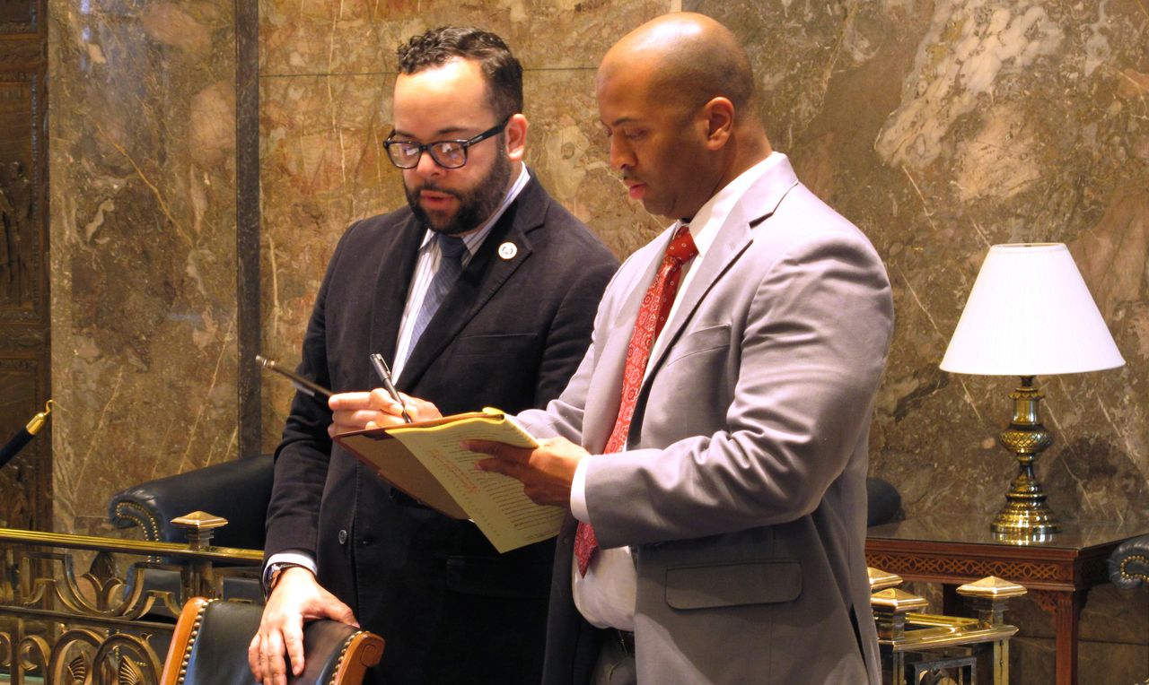 Louisiana state Sen. J.P. Morrell (D-New Orleans), at left on March 9, 2016, with a state Senate staff member, wants to strip a Jim Crow-era law from the state constitution that allows felony trials to be settled by divided juries.