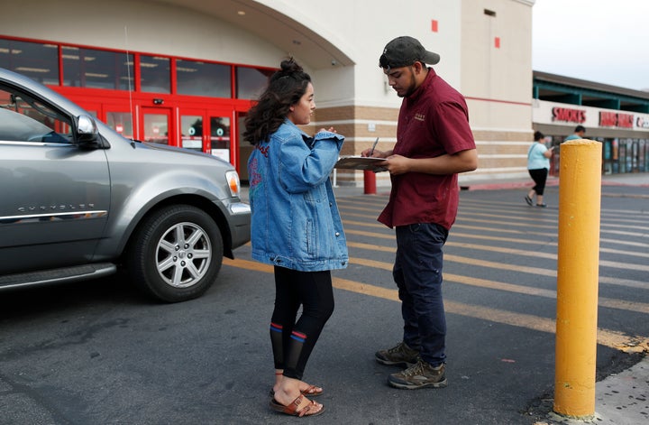 Jazmin Cortez registers Victor Arias to vote in Las Vegas in August. In a year in which the GOP targeted immigration as
