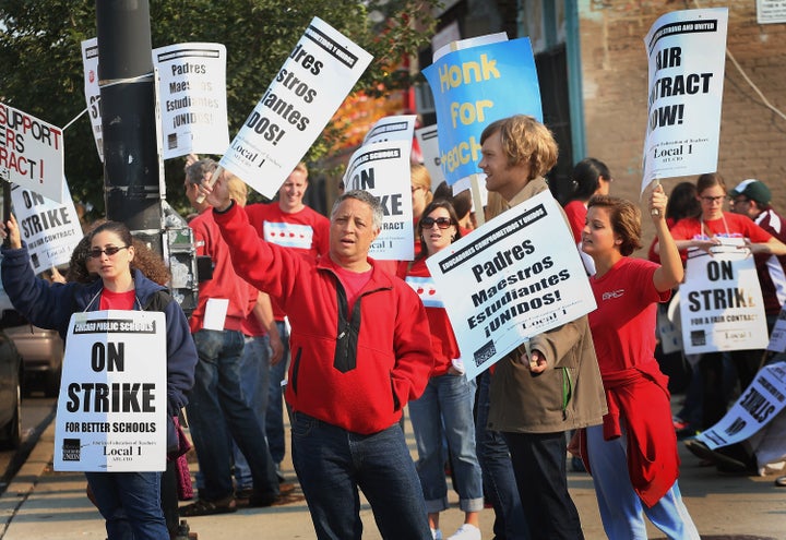 CHICAGO, IL - SEPTEMBER 17: Striking Chicago public school teachers picket outside of the Jose De Diego Community Academy on September 17, 2012 in Chicago, Illinois. More than 26,000 teachers and support staff walked off of their jobs on September 10 after the Chicago Teachers Union failed to reach an agreement with the city on compensation, benefits and job security. With about 350,000 students, the Chicago school district is the third largest in the United States. (Photo by Scott Olson/Getty Images)