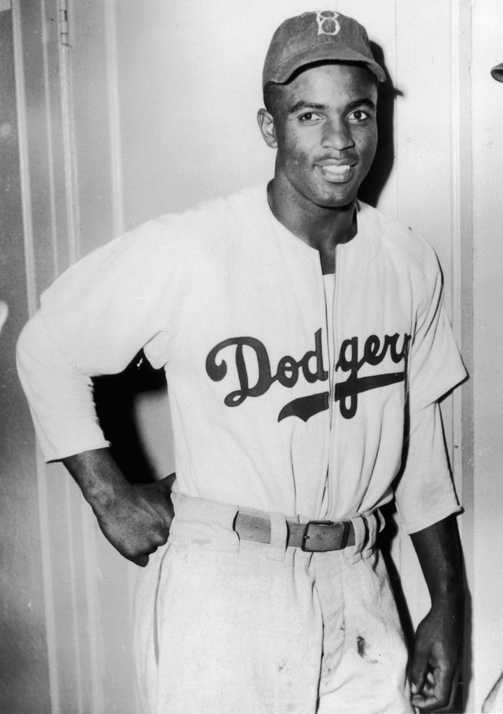 circa 1945: American baseball player Jackie Robinson (1919-1972) leans against a door in his Brooklyn Dodgers uniform. (Photo by Hulton Archive/Getty Images)