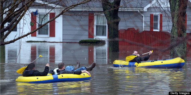 Nick Ariano, from left, Rick Watson and Keith Andrzejewski head out to rescue the grandmother of Andrzejewski, near Ogden and Rt. 53 in Lisle, Illinois, during heavy flooding on Thursday, April 18, 2013. (Antonio Perez/Chicago Tribune/MCT via Getty Images)