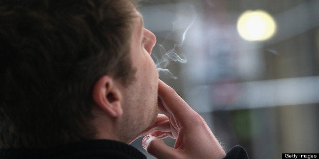 NEW YORK, NY - APRIL 23: A smoker enjoys a cigarette outside an office building on April 23, 2013 in New York City. The lega