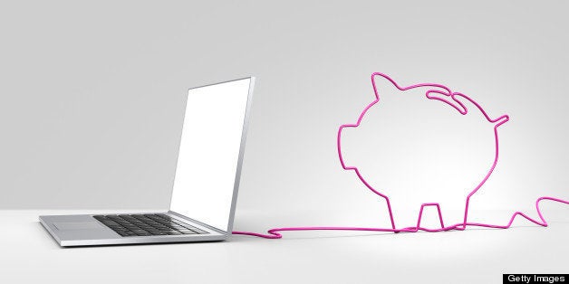 Laptop computer with a pink ethernet cable forming a piggy bank, coming out of the back on a plain background