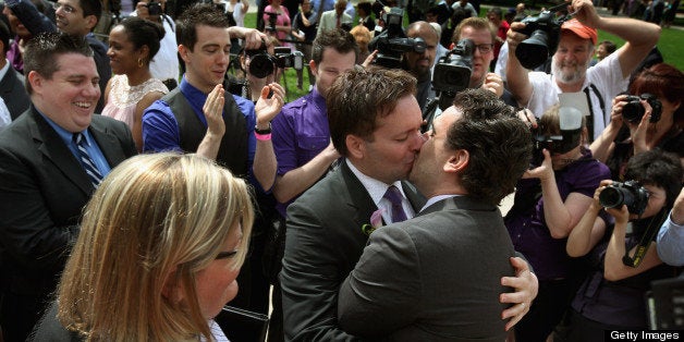 CHICAGO, IL - JUNE 02: Robert Hunt (L) and Frank Baiocchi kiss after exchang vows during a civil union ceremony in Millennium Park June 2, 2011 in Chicago, Illinois. More than 30 same-sex couples were joined in civil unions today during a ceremony in the park. Illinois is the sixth state to allow same-sex civil unions or their equivalent, which provide gay couples the same rights as heterosexual married couples. (Photo by Scott Olson/Getty Imagesng)