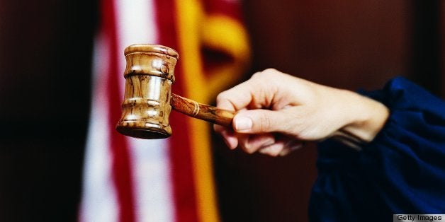 Close Up of a Magistrate Holding a Gavel in a Courthouse