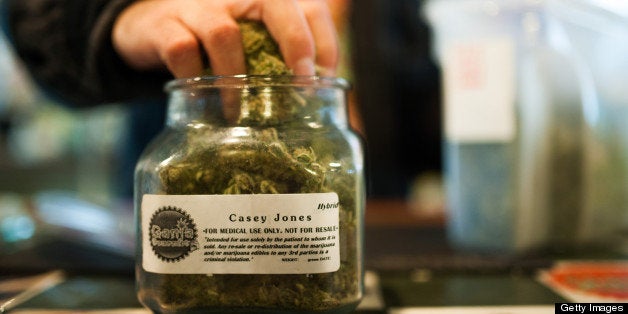 An employee of Ganja Gourmet in Denver, Colorado, re-stocks 'top shelf' medical marijuana in the business's retail space on A