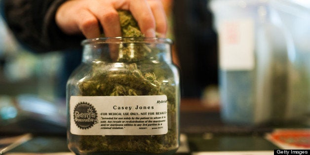 An employee of Ganja Gourmet in Denver, Colorado, re-stocks 'top shelf' medical marijuana in the business's retail space on April 17, 2013. (Dustin Bradford/MCT via Getty Images)