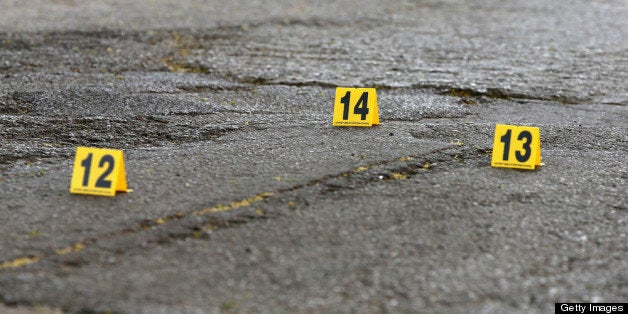 CHICAGO, IL - MAY 14: Markers placed by Chicago police protect for evidence shell casings that dropped in the street near the location where two men were shot and wounded in the South Shore neighborhood on May 14, 2013 in Chicago, Illinois. The shooting was the first of several that left two men dead and 11 others wounded in the city between Monday afternoon and the early hours of Tuesday morning. (Photo by Scott Olson/Getty Images)