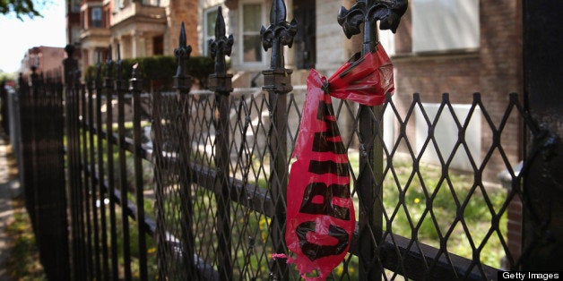 CHICAGO, IL - MAY 13: Crime scene tape hangs from a fence near the location where 21-year-old Ronald Baskin was shot and kil